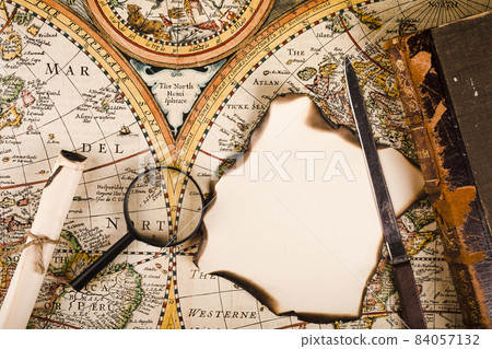elevated view magnifying glass burnt paper knife map. High quality beautiful photo concept 84057132