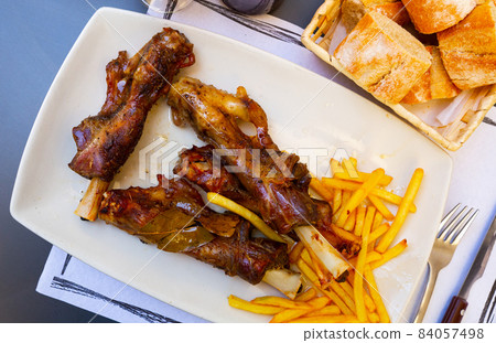 Caldereta de cordero - lamb bone with french fries Caldereta de cordero - lamb bone with french fries 84057498