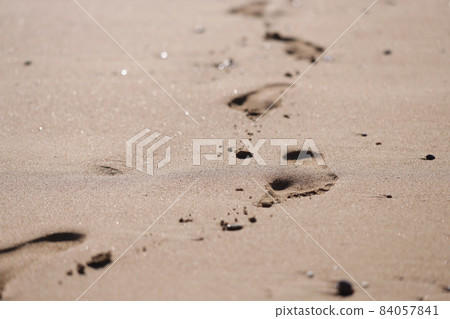 Human foot prints on golden beach sand Human foot prints on golden beach sand 84057841