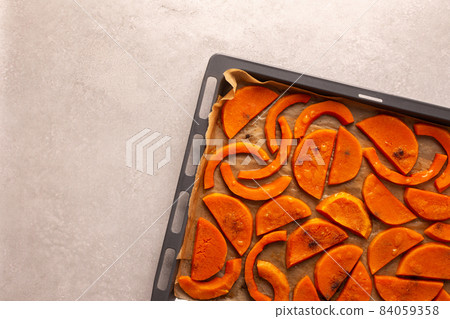 Baked sweet pumpkin on a baking sheet 84059358