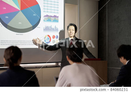Asian businessman giving a presentation at a conference Asian businessman giving a presentation at a conference 84060231