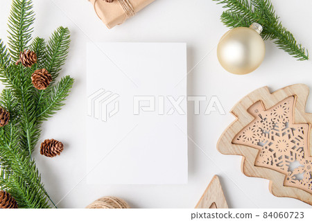 Christmas 5x7 card mockup template with fir twigs and golden stars on white background Christmas 5x7 card mockup template with fir twigs and golden stars on white background 84060723