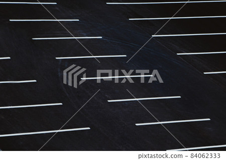Empty parking during quarantine in the city. White markings for cars on black asphalt. Empty parking during quarantine in the city. White markings for cars on black asphalt. 84062333