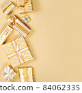 Many different luxury stylish gift boxes in golden tones. 84062335