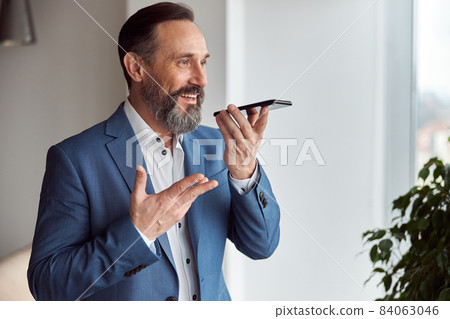 Happy adult caucasian man is working in a modern office Happy adult caucasian man is working in a modern office 84063046