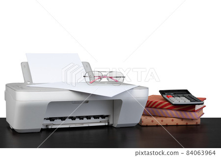 Printer and stack of books on black table against white background Printer and stack of books on black table against white background 84063964