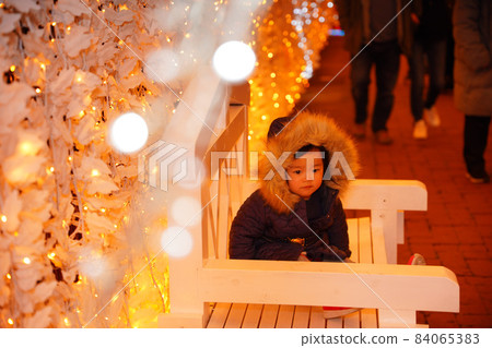 A girl sitting in an illuminated chair A girl sitting in an illuminated chair 84065383