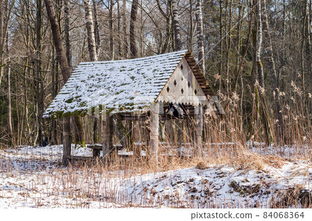 Forest gazebo. A place in the woods for travelers to relax. A table and benches in the forest. Forest gazebo. A place in the woods for travelers to relax. A table and benches in the forest. 84068364