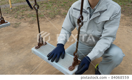Workers inspecting swings | Inspection image of park playset Workers inspecting swings | Inspection image of park playset 84068559