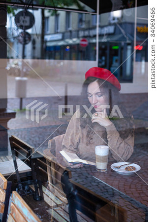Romantic pretty woman outside cafe window Romantic pretty woman outside cafe window 84069466