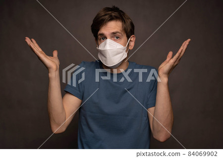 Young man with face mask on grey Young man with face mask on grey 84069902