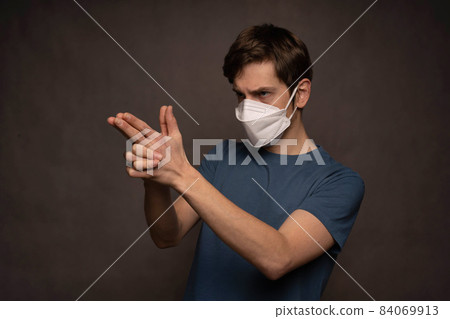 Young man with face mask on grey Young man with face mask on grey 84069913