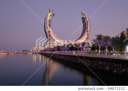 Lusail Corniche  in Lusail city, Qatar at the marina sunset shot showing people walking on the promenade with skyline in background 84071152