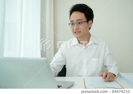 Asian businessman working at home. Asian businessman working at home. 84074233