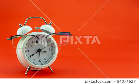 Concept Education or business Alarm clock and teacher glasses Business objects isolated on colorful background Back to school concept Concept Education or business Alarm clock and teacher glasses Business objects isolated on colorful background Back to school concept 84074627