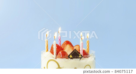 Burning candles and whole cake 84075117