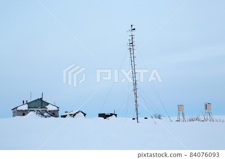 Abandoned weather station in a snow-covered tundra. 84076093