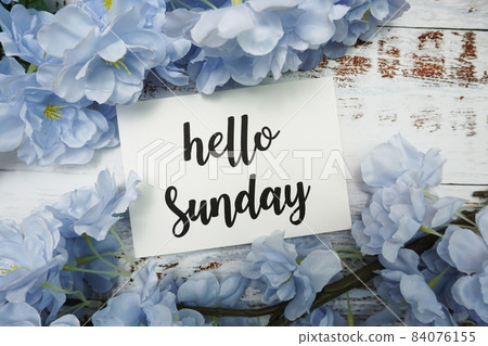 Hello Sunday Card with Blooming flower on wooden background Hello Sunday Card with Blooming flower on wooden background 84076155