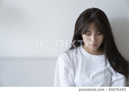Portrait of a woman looking down in the room Portrait of a woman looking down in the room 84076495