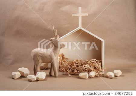 Minimal eco Christmas concept. House and deer made of wood and paper. DIY organic sustainable Christmas decoration. 84077292