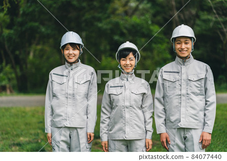 Worker wearing a helmet Worker wearing a helmet 84077440