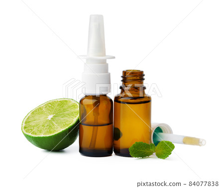 Essential oil bottles and citrus fruit on white background Essential oil bottles and citrus fruit on white background 84077838