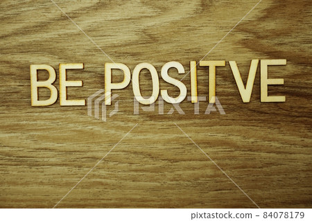 Be Positive text message on wooden background Be Positive text message on wooden background 84078179