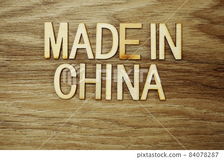 Made In China text message on wooden background Made In China text message on wooden background 84078287