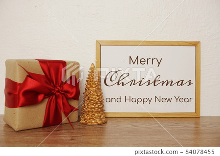 Merry Christmas and Happy New Year text with giftbox and Christmas tree decorate Merry Christmas and Happy New Year text with giftbox and Christmas tree decorate 84078455