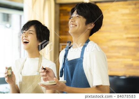 Men and women looking at computers side by side 84078583