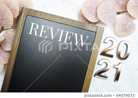 Review 2021 with space copy on blackboard with eucalyptus leaves on marble background Review 2021 with space copy on blackboard with eucalyptus leaves on marble background 84079033