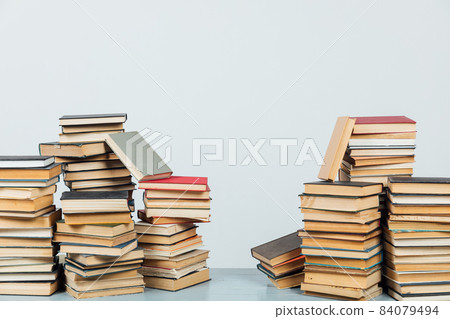 stacks of educational books in the college library on a white background 84079494