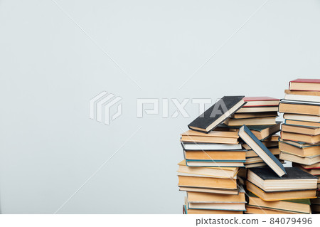 stacks of educational books in the college library on a white background 84079496