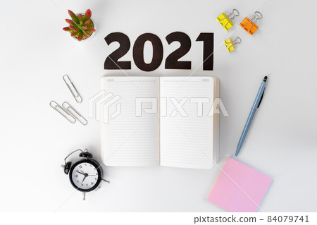 Year 2022 numbers and stationery on white table Year 2022 numbers and stationery on white table 84079741