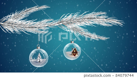 Two clear Christmas baubles dangling from Christmas tree against snowflakes falling on blue backgrou 84079744