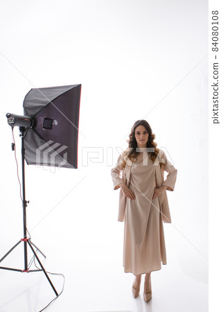 A model with a beautiful makeup in the studio on a white background. professional shooting and lighting in the studio 84080108