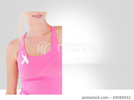Mid section of caucasian woman wearing pink ribbon on her sleeve against grey background 84080832