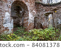 The ruins of an ancient red brick church with remnants of white plaster. 84081378