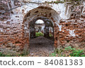 The ruins of an ancient red brick church with remnants of white plaster. 84081383