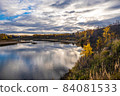 Autumn water landscape with reflection in the river of cloudy sky and yellow trees on the shore. 84081533