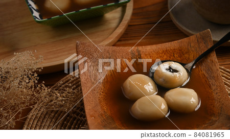 Close up black sesame dumplings in ginger soup. 84081965
