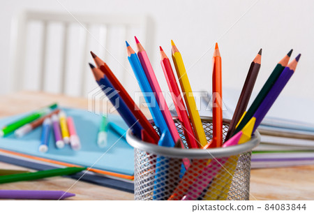 Pencils, papers and workbooks on desk Pencils, papers and workbooks on desk 84083844