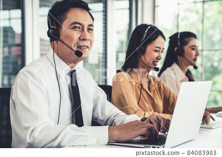 Business people wearing headset working actively in office 84083983