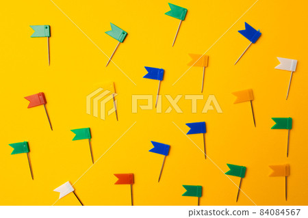 Color push pins pattern on yellow background Color push pins pattern on yellow background 84084567