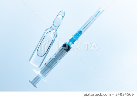 Medical vial with medication and syringe close up 84084569