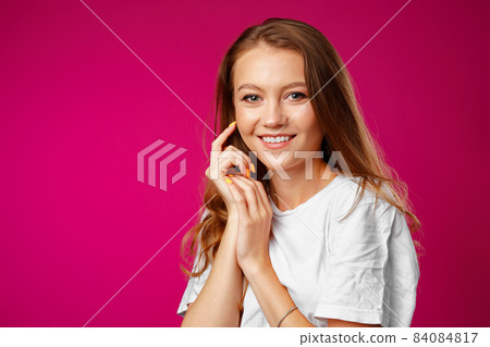 Portrait of a young beautiful happy woman smiling Portrait of a young beautiful happy woman smiling 84084817