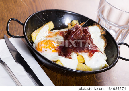 Broken eggs with Jabugo ham Broken eggs with Jabugo ham 84085574