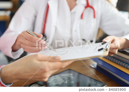 Female doctor and patient signing medical contract Female doctor and patient signing medical contract 84085900