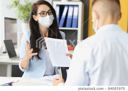 Female leader talk to employee point and explain mistakes in report Female leader talk to employee point and explain mistakes in report 84085970