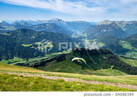 paragliding flight in the mountains. Le Grand-Bornand, France 84086384